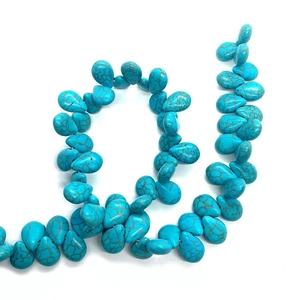 Detailed view of teardrop blue turquoise stone beads with brown matrix for DIY jewelry