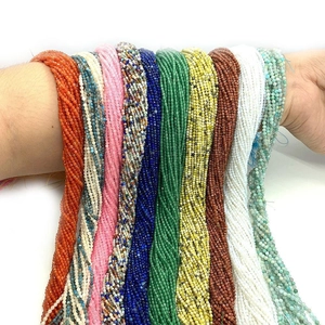 Detailed view of 2mm faceted natural stone beads in multiple colors shown on a wrist