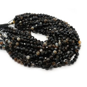 Faceted black striped agate beads in spiral layout for DIY jewelry making