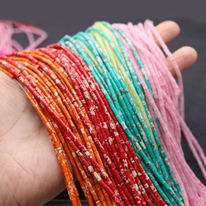 Handheld view of colorful 2x4mm natural stone heishi tube beads for DIY jewelry making