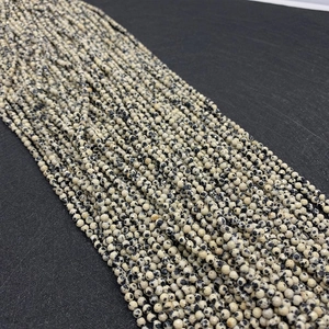 Macro detail of faceted Dalmatian Jasper beads for DIY jewelry making and crafts