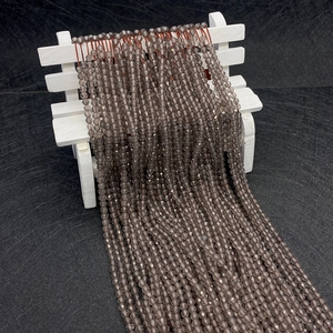 Faceted natural smoky quartz beads for DIY jewelry making on a mini white bench