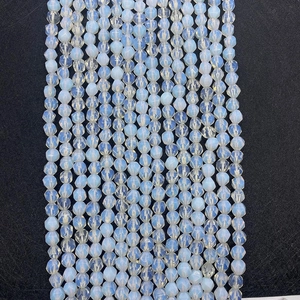 Vertical rows of faceted translucent light blue opal beads showing diamond-shaped textures