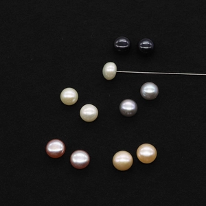 Close-up of natural freshwater pearls with detailed drill holes and multi-color luster