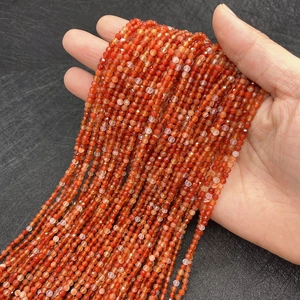 Faceted natural red agate beads 2-4mm for DIY jewelry making held in hand as strands