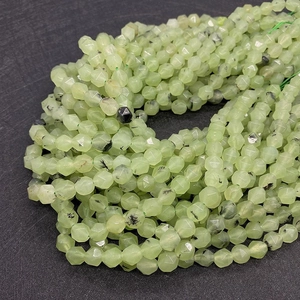 Macro detail of faceted green prehnite beads with natural black inclusions for DIY jewelry