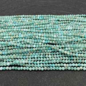 Macro detail of faceted natural amazonite round beads showing blue-green mineral texture