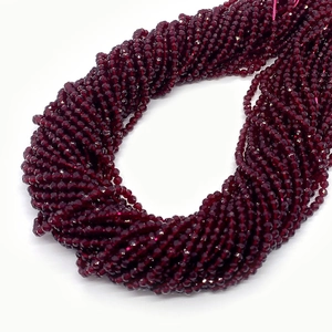 Macro detail of faceted dark red gemstone beads with precise cutting for DIY jewelry