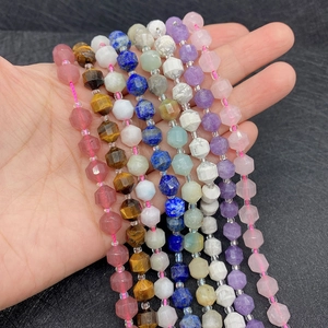Macro detail of multi-faceted 8mm natural stone beads in assorted gemstone colors