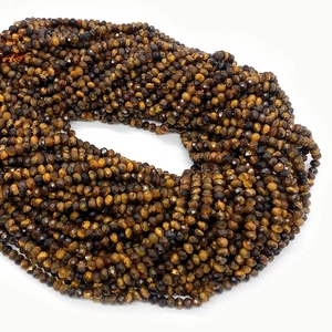 Macro detail of faceted tiger eye stone beads in brown and gold for DIY jewelry