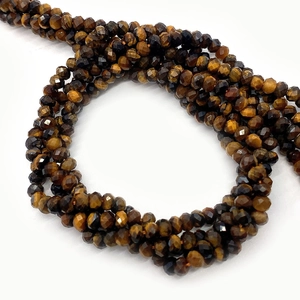 Macro shot of faceted natural tiger eye stone beads showing unique golden-brown texture