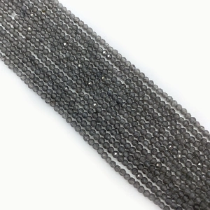 Macro shot of faceted grey cat eye glass beads for jewelry making with polished finish