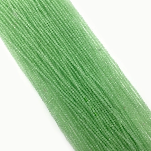 Macro shot of light green cat eye stone beads strands with translucent polished texture