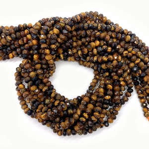 Faceted natural tiger eye gemstone beads for DIY jewelry making on white background