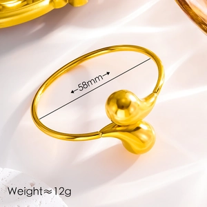 Detailed view of gold open cuff bracelet showing 58mm inner diameter and 12g weight