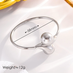 Detail showing polished silver bangle with 58mm inner diameter and two metal spheres