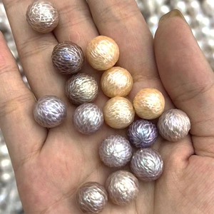 Macro shot of 13mm purple and gold dragon-scale carved natural freshwater pearls