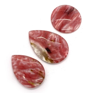 Polished natural pink agate pendants in round and teardrop shapes with unique patterns