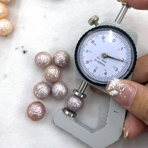 Measuring a textured 12mm natural freshwater dragon scale pearl with a thickness gauge