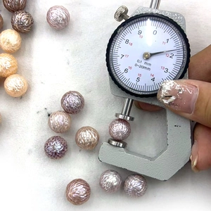 Macro shot measuring 12.2mm carved freshwater pearl with detailed geometric facets
