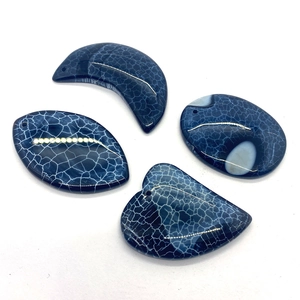 Detailed view of four deep blue dragon vein agate pendants with unique white web patterns