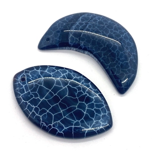 Macro detail of blue dragon vein agate pendants in crescent and marquise shapes for DIY