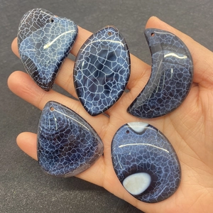 Macro detail of five assorted dragon vein agate pendants in deep blue with white veins