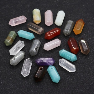 Close-up of hexagonal crystal prisms with vertical holes for DIY jewelry making