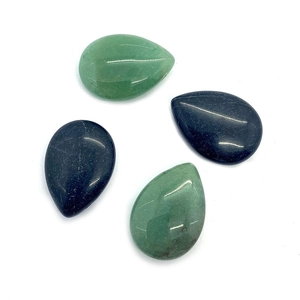 Macro detail of teardrop aventurine and black agate loose beads with polished finish
