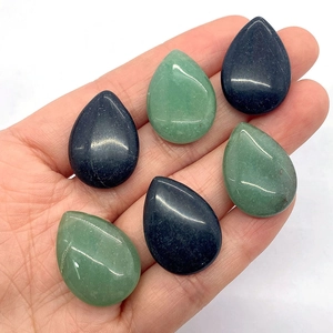 Polished 18x25mm teardrop stone cabochons in green aventurine and black onyx held in hand