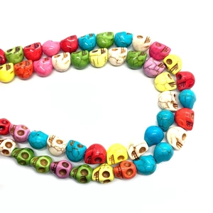 Macro shot of colorful skull-shaped turquoise beads with vintage cracked texture for DIY jewelry