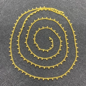 Detailed macro view of 2mm golden round ball chain for DIY jewelry making accessories