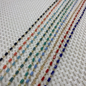 Detail of colorful stone cylinder beads and gold copper chain for DIY jewelry making