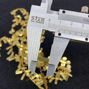 Macro view of measuring a 6mm golden twist chain link with a digital caliper