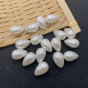 Macro detail of tear-drop shaped white imitation pearl beads for DIY jewelry making