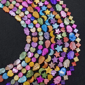 Macro shot of colorful shell beads in various shapes like heart star and flower
