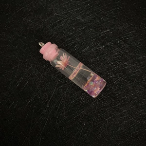 Elegant cylinder glass bottle pendant with pink dried flower and purple glitter liquid