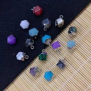 Detailed macro shot of faceted natural stone pendants with silver metal bails for DIY jewelry