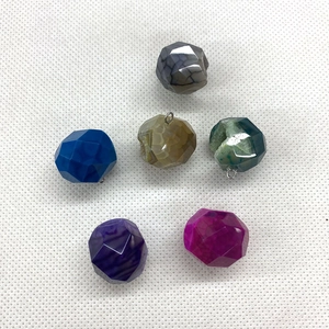 Detailed view of faceted round natural stone pendants in six assorted vibrant colors