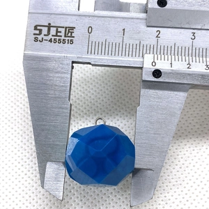 Macro shot showing 18mm faceted blue crystal stone pendant measured with a caliper