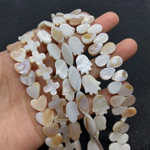 Detailed view of mixed shapes natural freshwater shell beads for DIY jewelry making