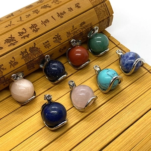 Macro detail of assorted natural gemstone round pendants with silver claw settings