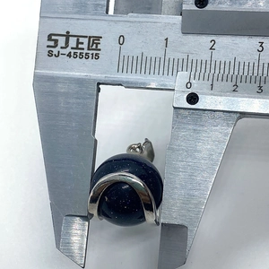 Detailed measurement of blue sand stone ball pendant with silver clasp using a caliper