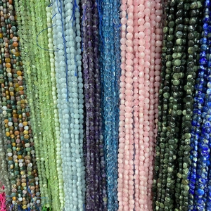 Macro shot of assorted natural gemstone beads like amethyst and rose quartz for DIY jewelry
