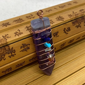 Copper wire wrapped amethyst hexagon point pendant with seven chakra stones detail