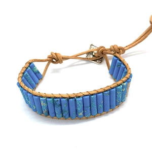 Bohemian style bracelet with blue turquoise stone tubes and brown leather cord closure