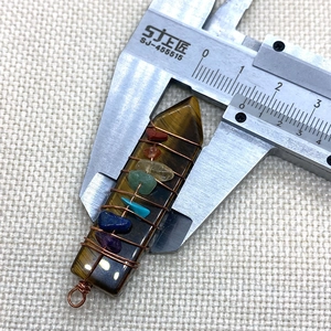 Tiger eye crystal hexagonal pendant measured with caliper showing 14mm width detail