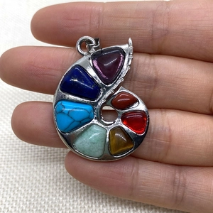 Spiral snail-shaped pendant featuring seven colorful natural gemstones in a silver setting