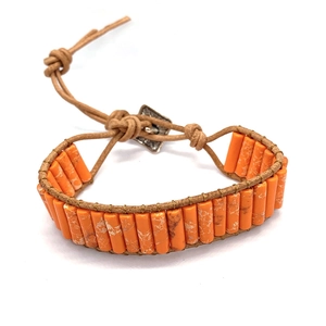 Ethnic tube bead leather bracelet featuring textured orange emperor stone and metal button