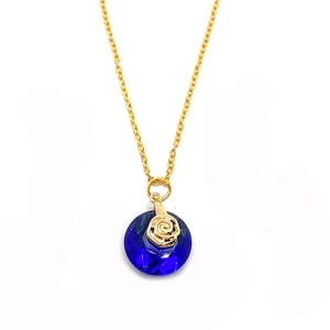 Macro shot of 14mm round faceted blue crystal pendant with a golden rose floral detail